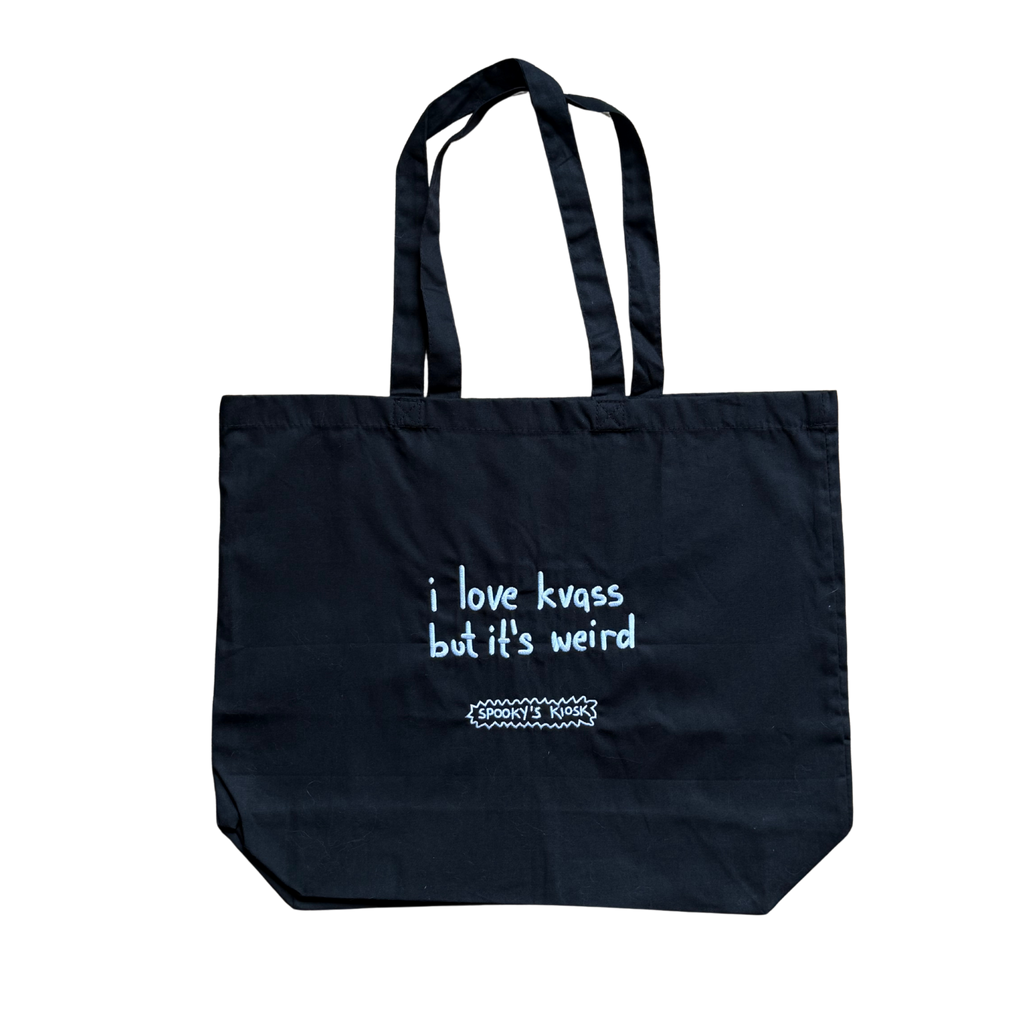 Black tote bag with white text on a white background