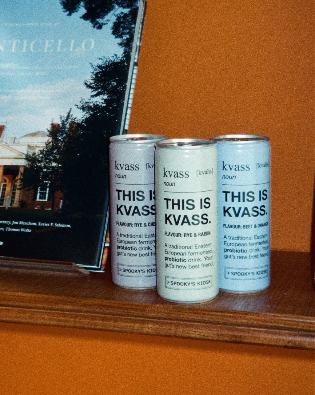 Three books titled 'This is Kvass' stacked on a shelf with a book below showing a cover of Monticello.
